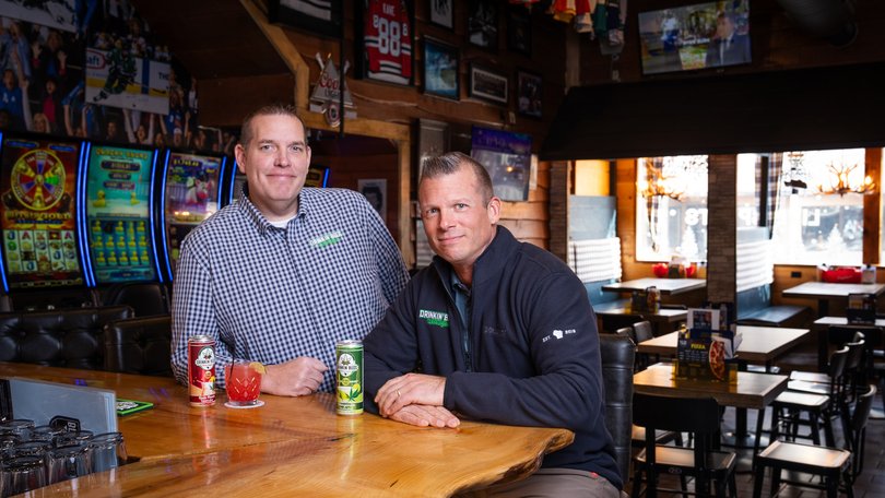 Justin Hopf, left, and Matt Swanson with cans of Drinkin’ Buds, the non-alcoholic THC-infused beverage brand they co-own.