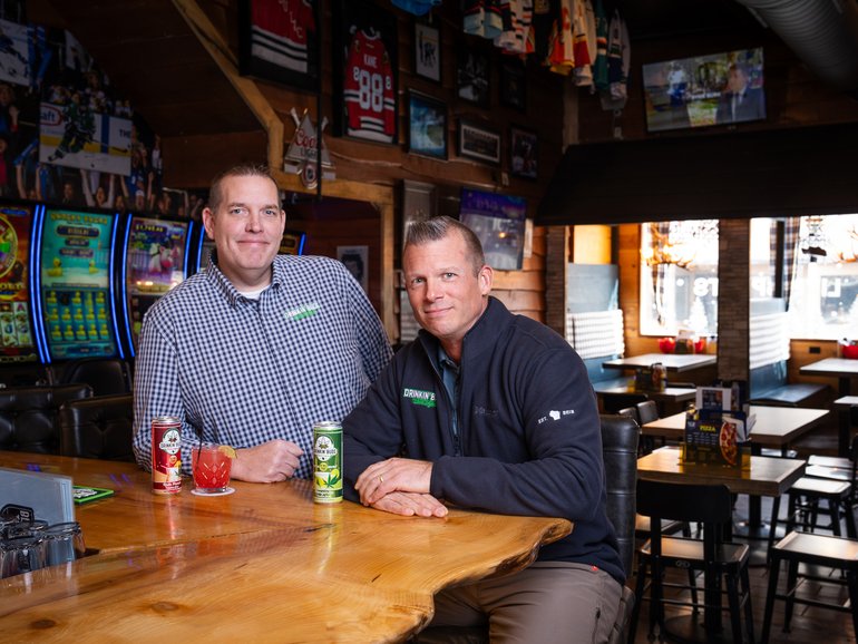 Justin Hopf, left, and Matt Swanson with cans of Drinkin’ Buds, the non-alcoholic THC-infused beverage brand they co-own.