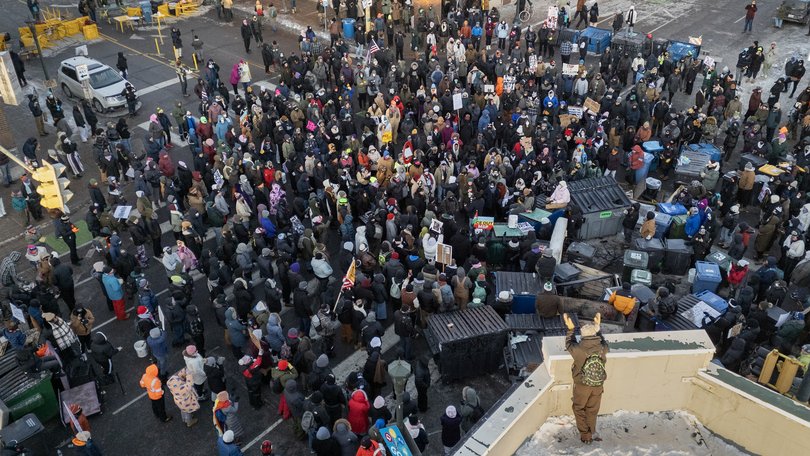 Protesters gather near the site in Minneapolis where Alex Pretti was shot and killed by federal immigration agents, on Saturday, January 24, 2026. 