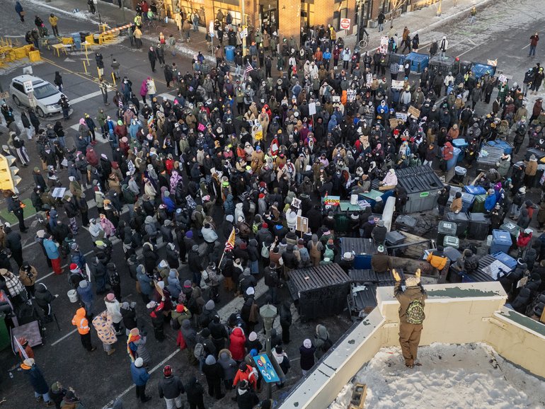 Protesters gather near the site in Minneapolis where Alex Pretti was shot and killed by federal immigration agents, on Saturday, January 24, 2026. 