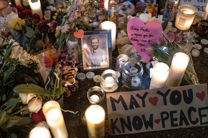 A photo of Alex Pretti is displayed at a makeshift memorial at the site where he was shot and killed by ICE agents in Minneapolis, Jan. 26, 2026. 