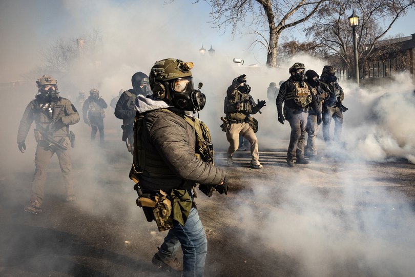 Federal agents deploy tear gas as they confront protestors in Minneapolis, near the site where federal agents shot and killed Alex Pretti on Saturday, Jan. 24, 2026.