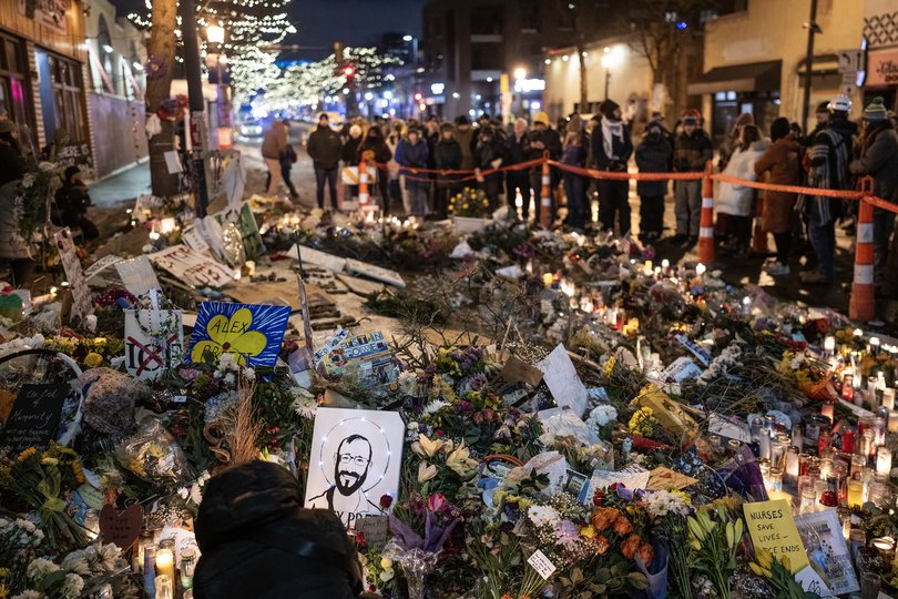 Mourners gather at a makeshift memorial at the site where Alex Pretti was shot and killed by ICE agents in Minneapolis, Jan. 26, 2026. 