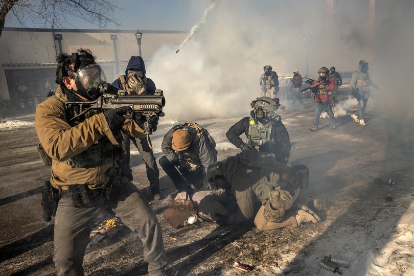 Federal agents confront protestors in Minneapolis, near the site where federal agents shot and killed a 37-year-old Minneapolis resident, on Saturday, Jan. 24, 2026.