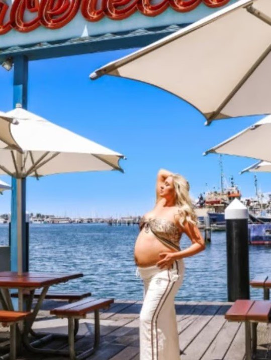 The 33-year-old mother-of-two wore nothing but white tracksuit pants and a leopard print top.