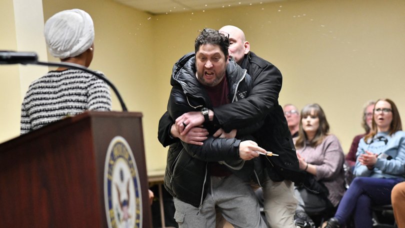 A man is tackled after spraying an unknown substance at US Representative Ilhan Omar.