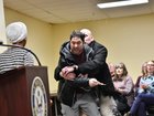 A man is tackled after spraying an unknown substance at US Representative Ilhan Omar.