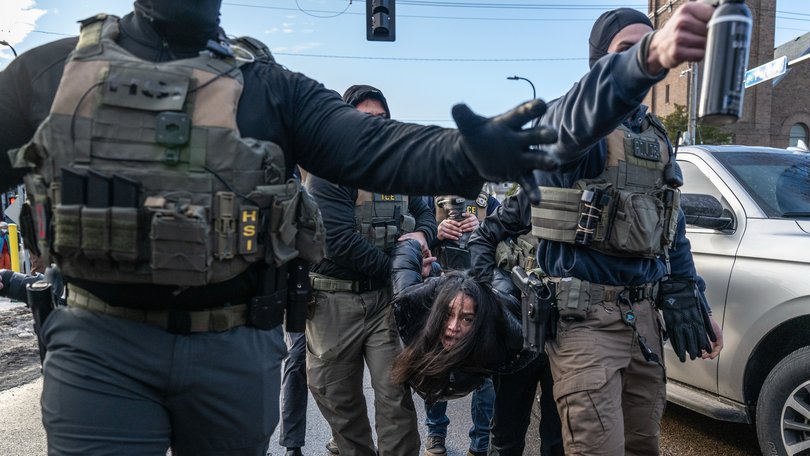 Federal law enforcement agents detain a motorist from a vehicle during a raid in Minneapolis, Minnesota, US, on Tuesday, Jan. 13, 2026. Minnesota officials are suing over the unprecedented surge of US immigration authorities in the state, taking the Trump administration to court days after a federal agent shot and killed a Minneapolis woman. Photographer: Victor J. Blue/Bloomberg Victor J. Blue