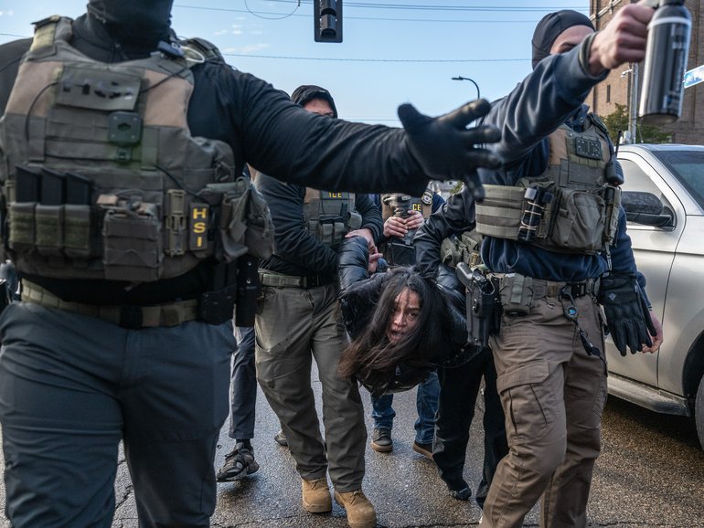 Federal law enforcement agents detain a motorist from a vehicle during a raid in Minneapolis, Minnesota, US, on Tuesday, Jan. 13, 2026. Minnesota officials are suing over the unprecedented surge of US immigration authorities in the state, taking the Trump administration to court days after a federal agent shot and killed a Minneapolis woman. Photographer: Victor J. Blue/Bloomberg Victor J. Blue
