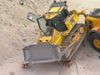 A worker has died after a bulldozer rolled over at a cement site.