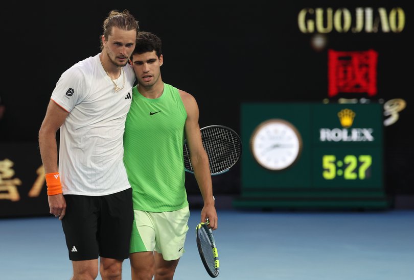 Carlos Alcaraz (R) of Spain embraces Alexander Zverev (L) of Germany after his victory in the Men's Singles Semifinal.