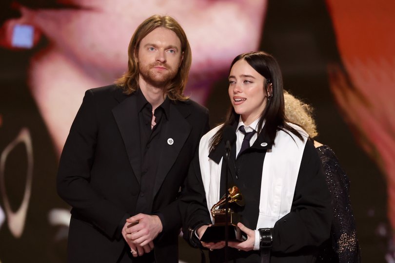 LOS ANGELES, CALIFORNIA - FEBRUARY 01: (L-R) Finneas O'Connell and Billie Eilish accept the Song of the Year award for "WILDFLOWER" onstage during the 68th GRAMMY Awards at Crypto.com Arena on February 01, 2026 in Los Angeles, California.  (Photo by Kevin Winter/Getty Images for The Recording Academy)