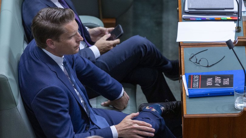Andrew Hastie with a copy of The Art of War during Question Time.