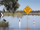 Around 450 people living in a remote outback town have been evacuated as floodwaters cut off roads. 