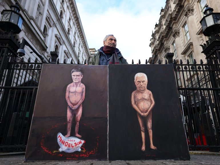 Political satire artist Kaya Mar with his paintings of British Prime Minister Keir Starmer and Andrew Mountbatten-Windsor outside Downing Street on February 4.