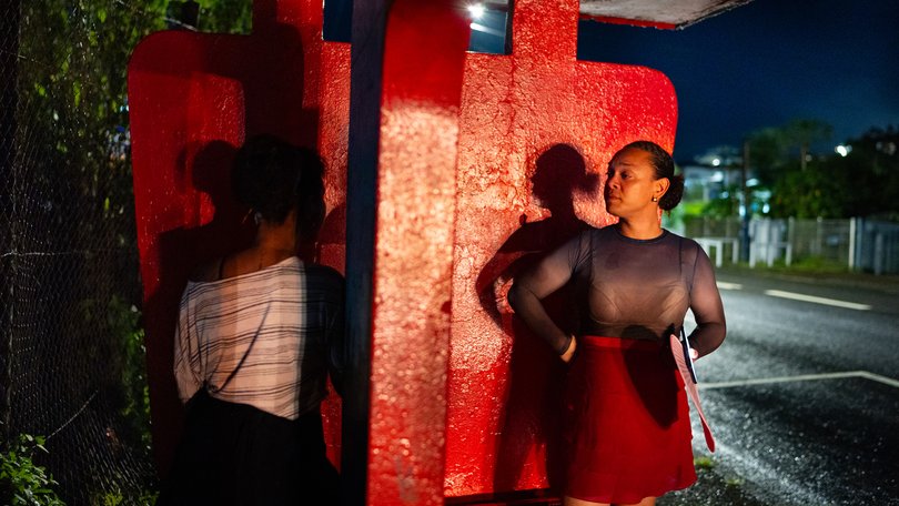 Elaine Monroe, 28, talks to a sex worker on a street in Suva