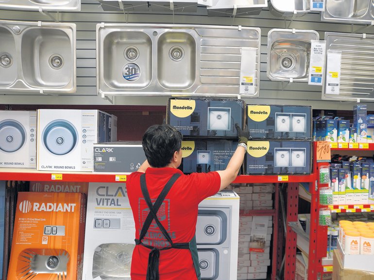 A Bunnings staff member checks shelves at a Melbourne store