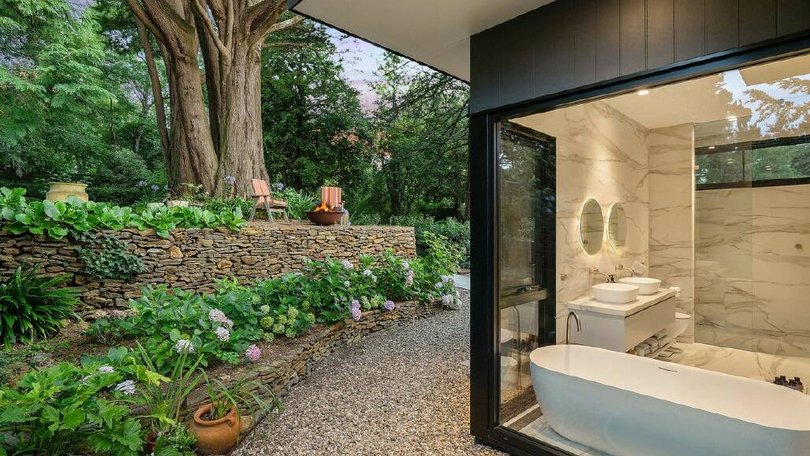 The Leura home even has a view of the garden from the bath.