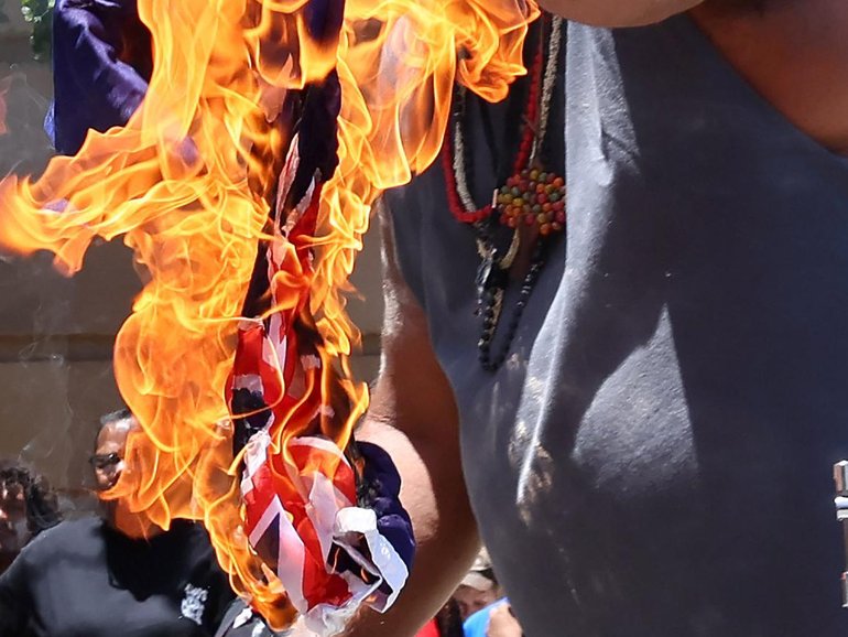 Two bills have been introduced to criminalise damaging the burning of the national flag. NewsWire / Tertius Pickard