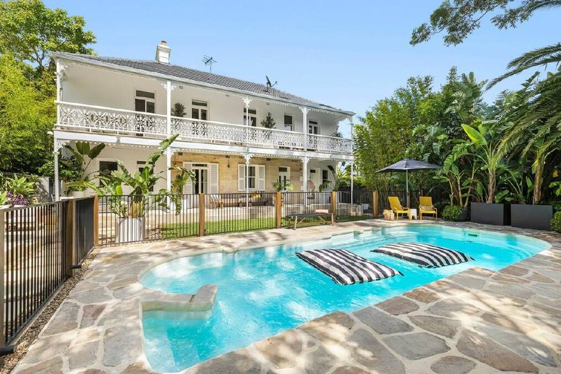 The house has balconies at the front and rear.