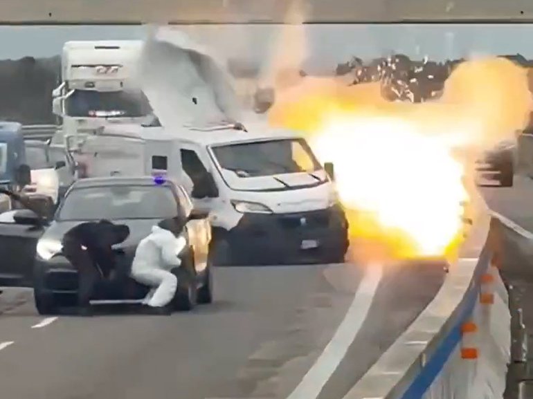 Heavily-armed robbers posing as police blocked an Italian highway and blew up an armoured van during a brazen raid in southern Italy, before exchanging gunfire with police. 