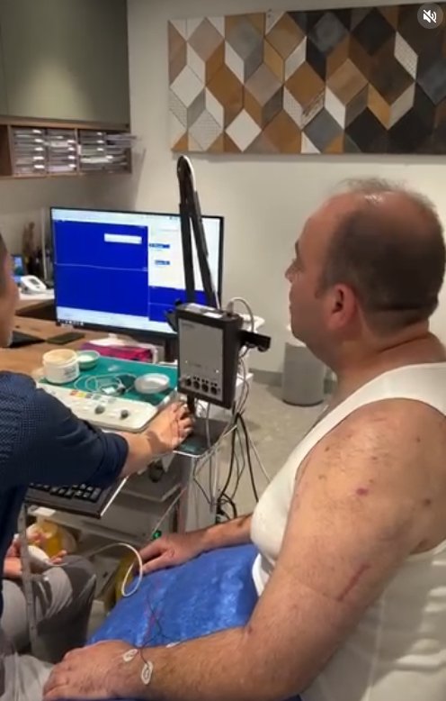 Ahmed Al Ahmed receiving nerve testing on his arm.