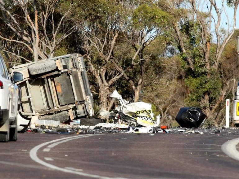 A collision between a police escort vehicle and a truck has put an officer in hospital with serious injuries.