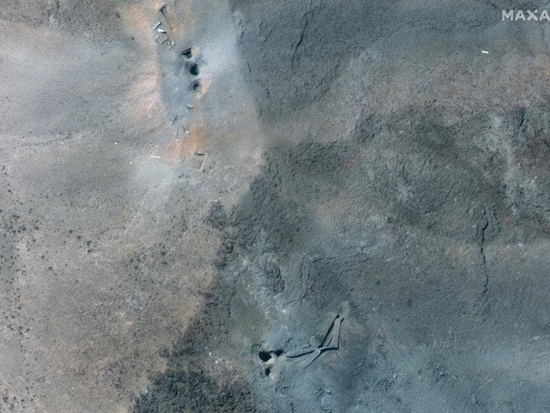 The craters caused by US bunker-buster bombs at the Fordo nuclear site are visible from space. (EPA PHOTO)