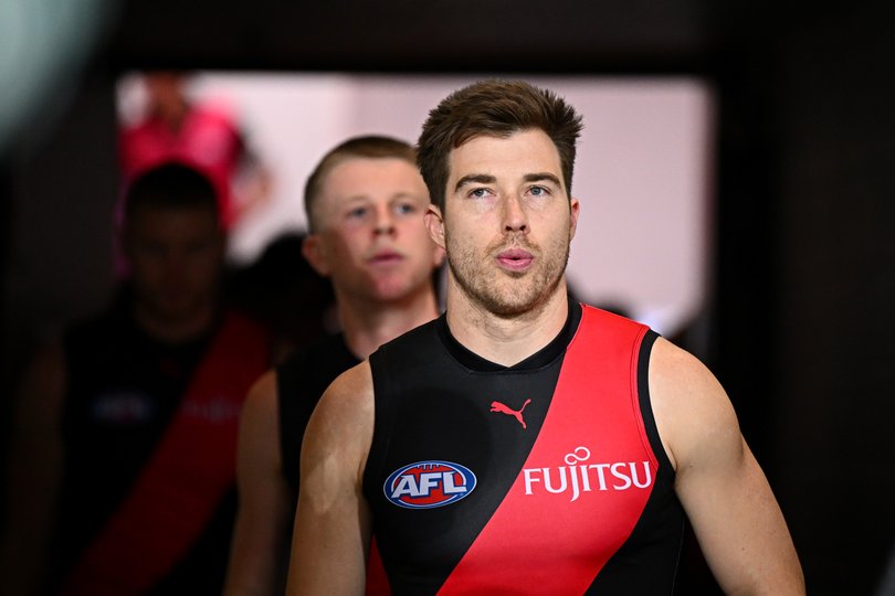Merrett leads Essendon out before the 2025 AFL Round 24 match against Gold Coast Suns.