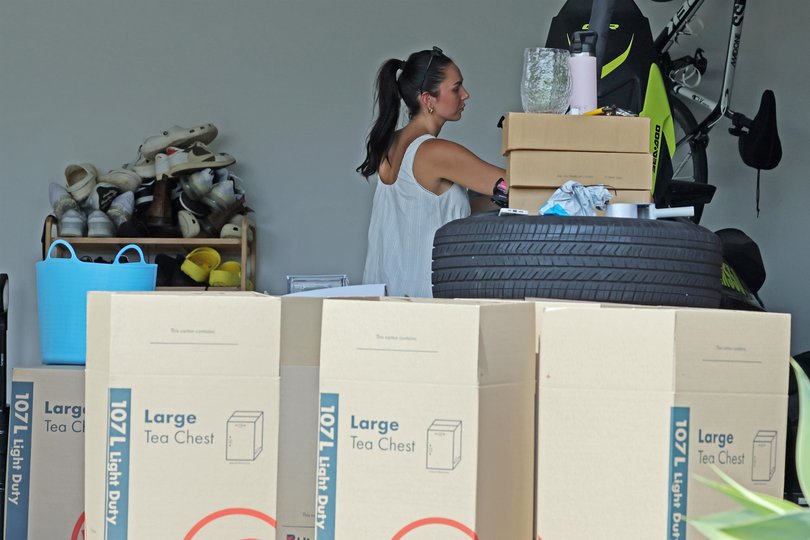 Tess Crosley seen packing removal boxes and leaving a free collection container out the front of the family home. 