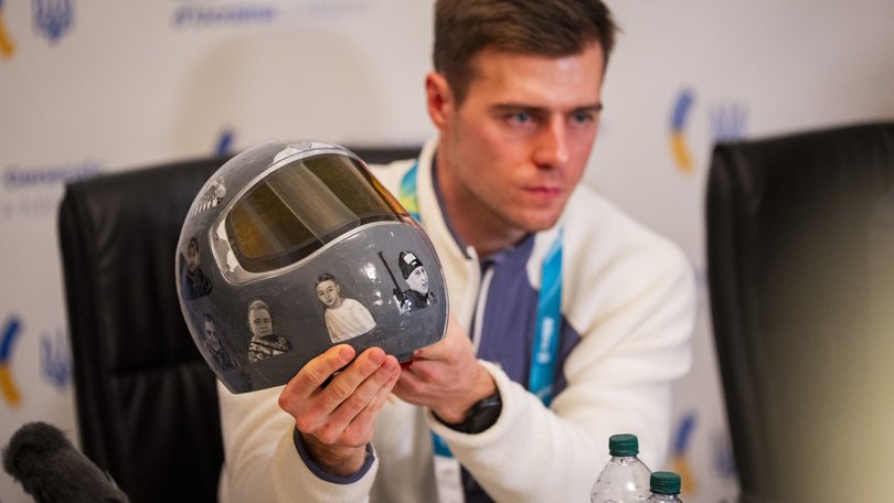 Vladyslav Heraskevych, a Ukrainian skeleton athlete, holds the helmet that led to his disqualification from the 2026 Milan Cortina Winter Olympics, at a press conference at the Ukrainian General Consulate in Milan on Thursday, Feb. 12, 2026. The IOCÕs decision to disqualify Heraskevych over his helmet honoring countrymen killed in the war with Russia touched off the biggest crisis of the Games in Italy. (Vincent Alban/The New York Times)