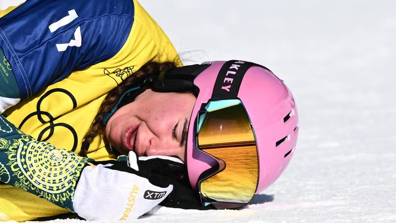 Josie Baff celebrates in the snow with tears of joy after winning gold at the Winter Olympics