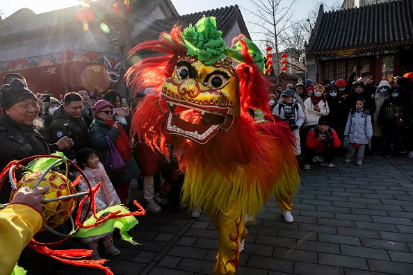 People watch a traditional lion dance for good luck and fortune during Chinese Lunar New Year Festivities.