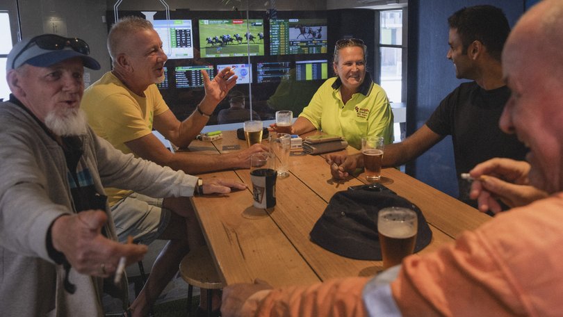 A group of friends in a designated smokers’ room at a pub in Sydney.