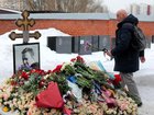 Mourners have placed floral tributes on the grave of Russian opposition figure Alexei Navalny.