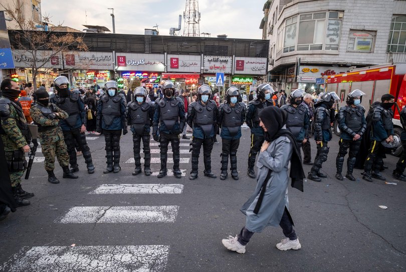 An Iranian woman walks past armed members of Iran's police special forces standing guard during a pro-Government rally in downtown Tehran, Iran, on January 12, 2026. The rally is held in Tehran against the recent anti-government unrest, opposition to the U.S. and Israel in Iran, and in support of Supreme Leader Ayatollah Ali Khamenei. (Photo by Morteza Nikoubazl/NurPhoto via Getty Images) Picture: NurPhoto