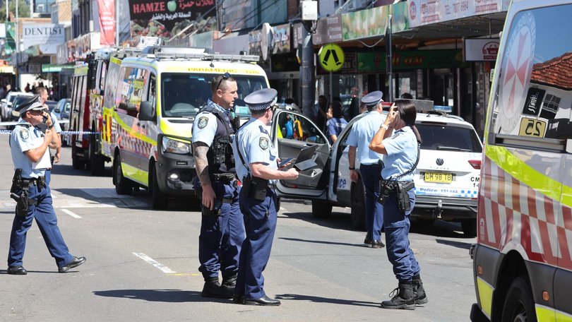 Police in Merrylands after three people were stabbed.