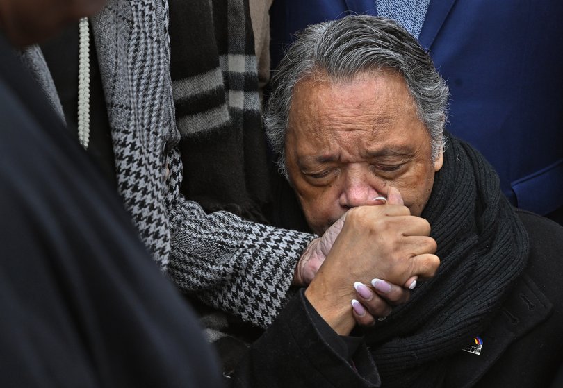 Rev. Jackson holds the hand of Rep. Maxine Waters during a prayer to remember the Bloody Sunday events on the Edmund Pettus Bridge in Selma in March 2025. MUST CREDIT: Michael S. Williamson/The Washington Post