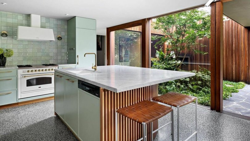 The sage green kitchen.