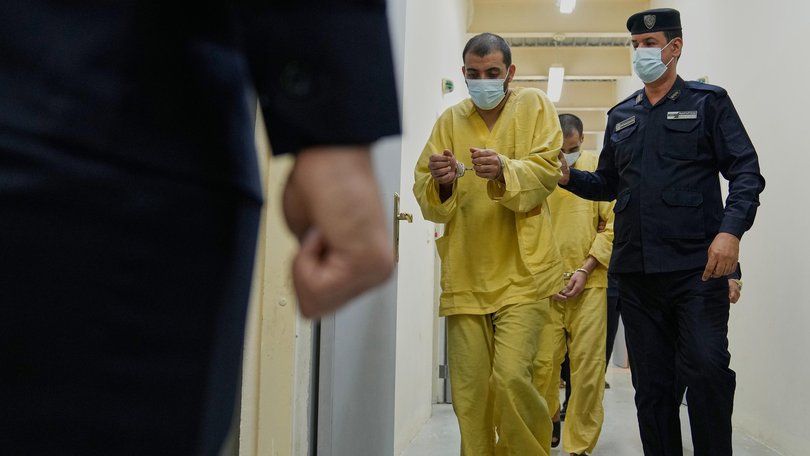 Iraqi security forces lead suspected Islamic State militants for questioning, after they were transferred from Syria to Iraq, at Al-Karkh Central Prison in Baghdad, Iraq, Thursday, Feb. 12, 2026. (AP Photo/Hadi Mizban) Hadi Mizban