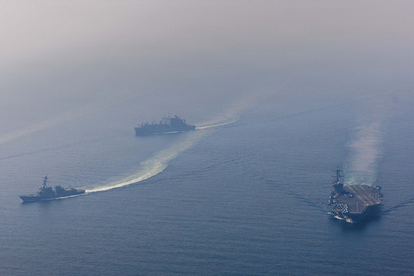 The Nimitz-class aircraft carrier USS Abraham Lincoln (CVN 72) sails alongside Arleigh Burke-class guided-missile destroyer USS Frank E. Petersen Jr (DDG 121) and Lewis and Clark-class dry cargo ship USNS Carl Brashear (T-AKE 7) in the Arabian Sea.