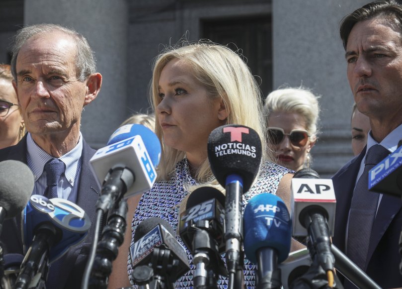 Virginia Giuffre, center, who says she was trafficked by sex offender Jeffrey Epstein, holds a news conference outside a Manhattan court in New York. On Monday, Aug. 9, 2021, Giuffre sued Prince Andrew saying he sexually assaulted her when she was 17.