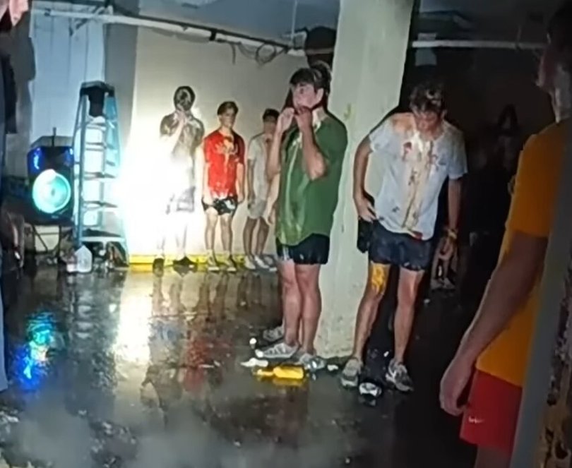 Some of the men appeared to be covered in food.