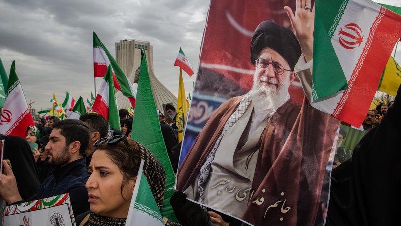 Thousands march carrying the national flag of the Islamic Republic of Iran and posters of Ayatollah Ali Khamenei to commemorate the 47th anniversary of the Islamic Revolution, in Tehran on Feb. 11, 2026.