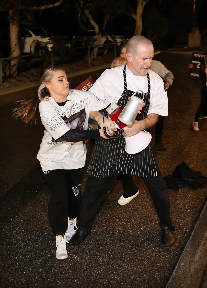 Owner and Head Chef John Mountain from Fyre Restaurant tries to grab a megaphone out of the hands of Tash Peterson.