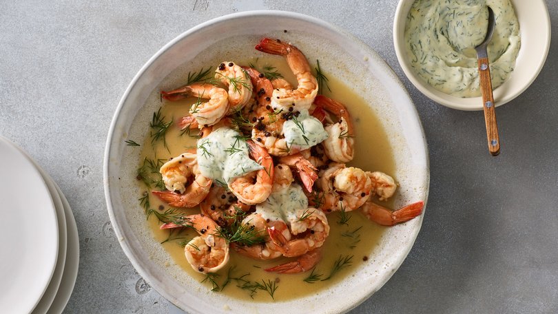Butter-poached prawns with dill mayonnaise in New York, March 8, 2023. Nix the garlic for coriander seeds and a dollop of dill-speckled mayo for a subtle, speedy dish that’s all about the prawns. Food styled by Barrett Washburne. (James Ransom/The New York Times)