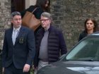 Peter Mandelson, centre, is escorted by police from a house to a car in London.