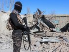 A Taliban security personnel stands next to the debris of houses destroyed during an overnight Pakistani airstrike at the Balish village in Urgun district, Paktika Province earlier in the week.