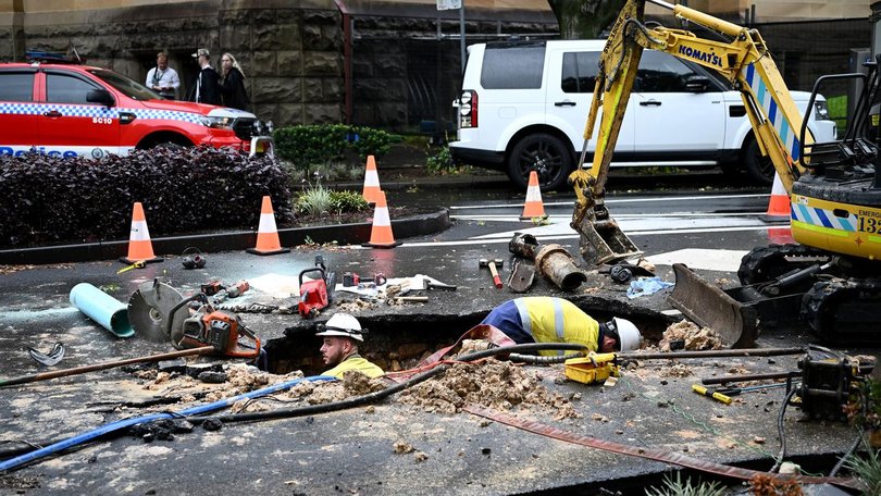 A burst water pipe is being blamed for a sinkhole which initially trapped a truck in the void. (Bianca De Marchi/AAP PHOTOS)