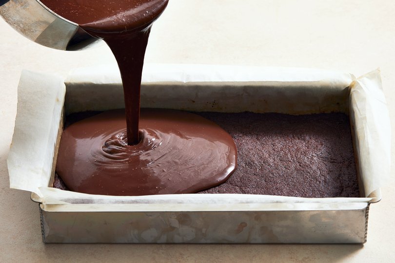 The filling is poured onto the crust for Genevieve Ko’s big chocolate tart. The addition of sweetened condensed milk ensures that the custard filling doesn’t break. Food stylist: Monica Pierini. (Armando Rafael/The New York Times)